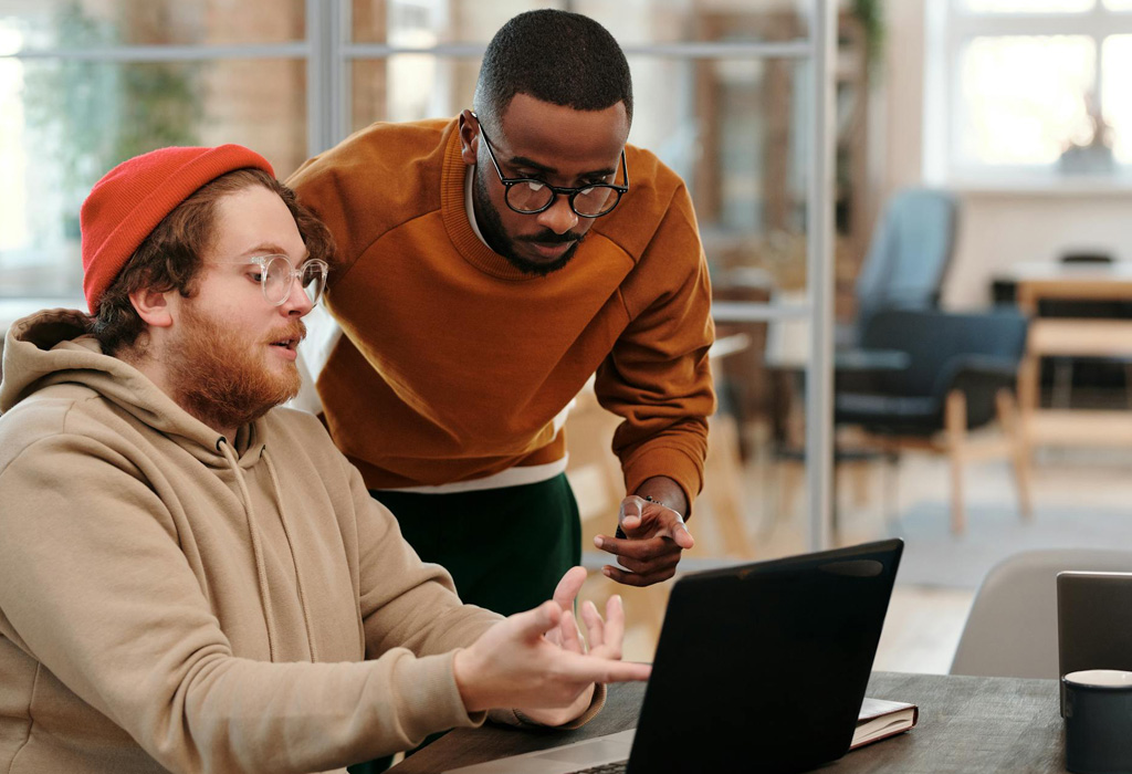 Two people working together to request a website service